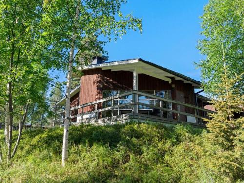 ein Haus auf einem Hügel mit Bäumen in der Unterkunft Holiday Home Valkeisrinne 1h by Interhome in Ruka