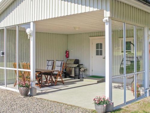 a screened in porch with a table and chairs at Holiday Home Metsätähti by Interhome in Vuokatti