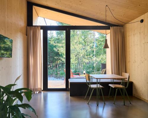 a dining room with a table and chairs and a window at KOKON Apartments in Leutasch