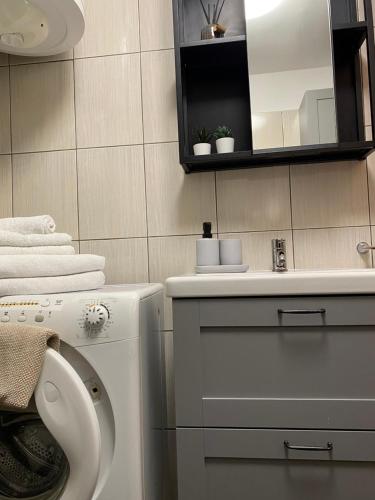 a bathroom with a toilet and a sink and a mirror at Apartma Izola in Izola