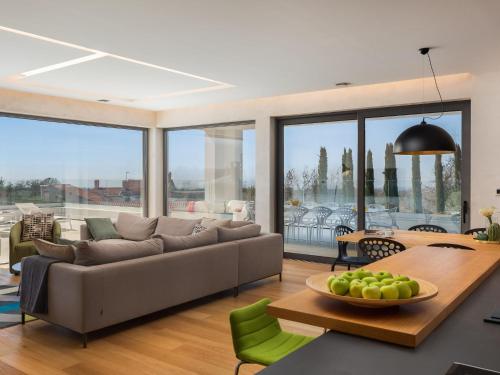 a living room with a couch and a table at Villa Old Olive I by Interhome in Vodnjan