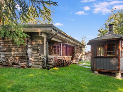a log cabin with a gazebo in the yard at Holiday Home Kelosyväri 17 by Interhome in Nilsiä