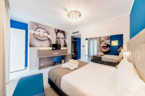 a bedroom with a large bed and blue walls at Diamante MHotel in Collegno