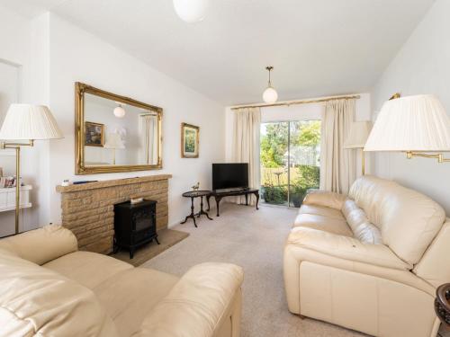 un soggiorno con mobili bianchi e camino di Holiday Home Broom Park by Interhome a Inverness
