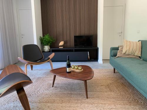 a living room with a couch and a table at Osbos chalets in Lille