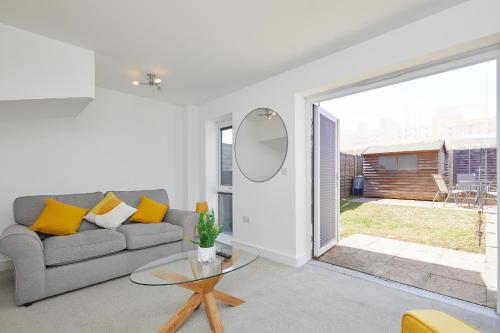 a living room with a couch and a glass table at Royal Derby Hospital Luxury House in Derby