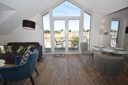 a living room with a couch and a table at Meeresblick-Storchennest-Haus-1-WE-13 in Hohwacht