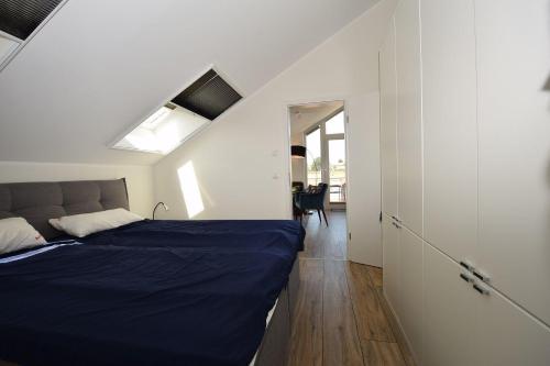 a bedroom with a bed and a room with a window at Meeresblick-Storchennest-Haus-1-WE-13 in Hohwacht