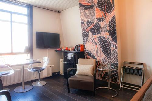 a living room with a chair and a wall at Zwanestein Canal House in Amsterdam