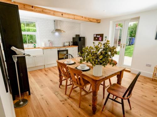 a kitchen with a wooden dining table and chairs at Pass the Keys Perfect for exploring the Wolds Lincoln in Market Rasen