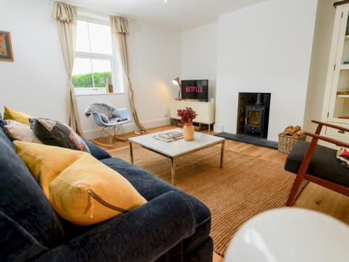 a living room with a blue couch and a table at Pass the Keys Perfect for exploring the Wolds Lincoln in Market Rasen