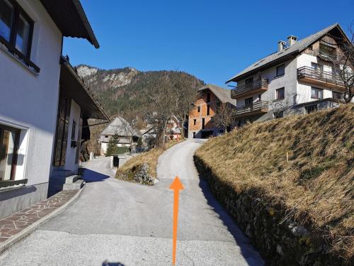 a winding road with an orange arrow pointing up at House of relaxation in Zgornja Sorica