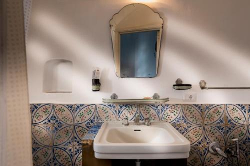 a bathroom with a sink and a mirror on the wall at La Sirena in Filicudi