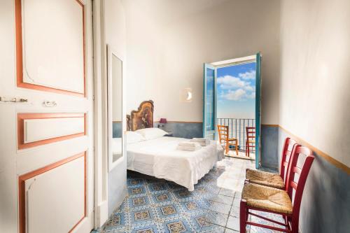 a bedroom with a bed and a view of the ocean at La Sirena in Filicudi