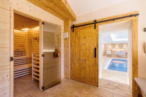 a bathroom with a door leading to a swimming pool at Rübezahlbaude in Großschönau