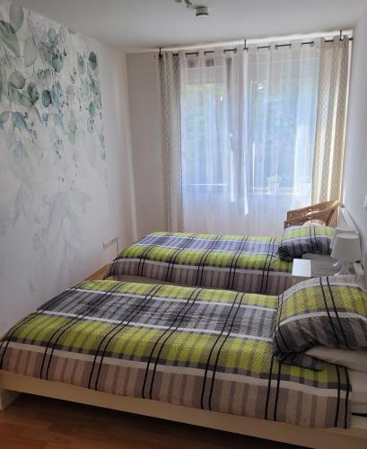a bedroom with a bed and a window at Ferienwohnung Burgblick in Wiesbaden