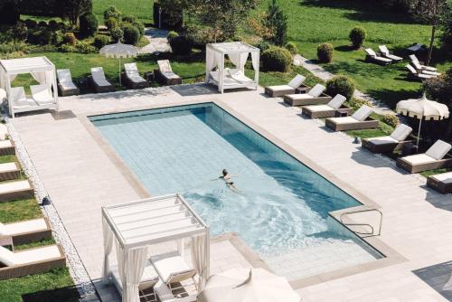 an overhead view of a swimming pool with a person in the water at Alpenpalace Luxury Hideaway & Spa Retreat in Lutago