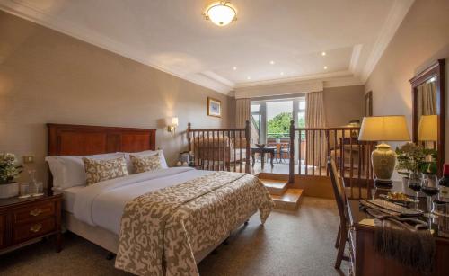 a hotel room with a bed and a balcony at Court Yard Hotel in Leixlip