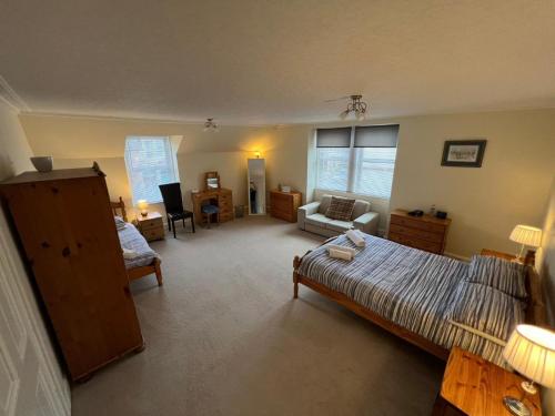 a large room with a bed and a living room at Ashley House in Inverness