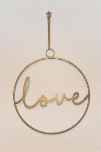 a gold name ornament hanging on a wall at Apartment Geislerhof by Interhome in Ramsau