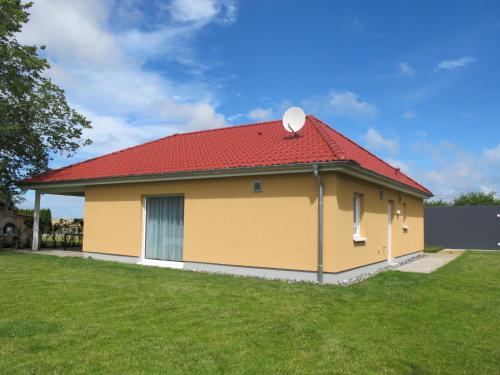 a yellow and red house with a red roof at Holiday Home Pusteblume by Interhome in Hessenburg