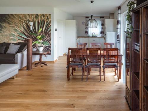 a kitchen and dining room with a table and chairs at Holiday Home Pusteblume by Interhome in Hessenburg