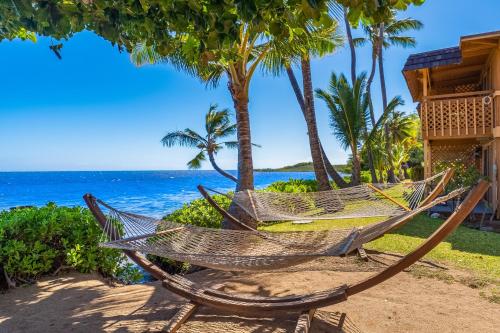 a hammock on the beach near the ocean at Vacasa at Hotel Molokai in Kaunakakai