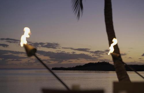 a group of people in the water at sunset at Vacasa at Hotel Molokai in Kaunakakai