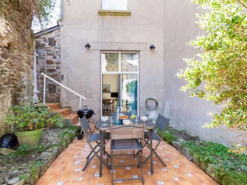 un patio avec une table et des chaises devant une maison dans l'établissement Apartment Vue Solidor-1 by Interhome, à Saint-Malo
