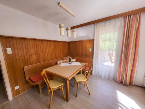 a dining room with a wooden table and chairs at Apartment Frieda by Interhome in Zams