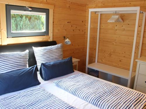 1 dormitorio con 2 camas y ventana en Holiday Home Ferienhaus Sarahlita by Interhome en Enspel