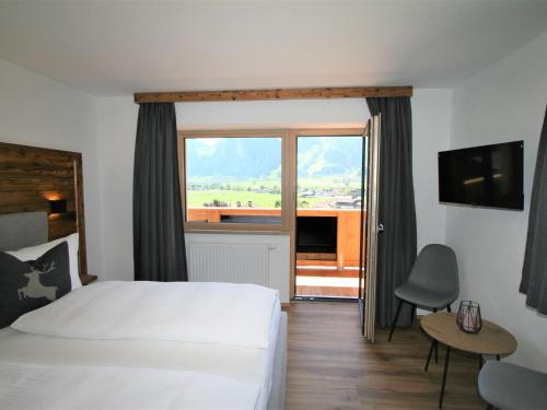 a hotel room with a bed and a large window at Apartment Geislerhof-1 by Interhome in Ramsau