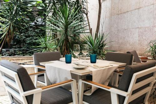 a table with chairs and a white table cloth at Hotel Marques De Pombal in Lisbon