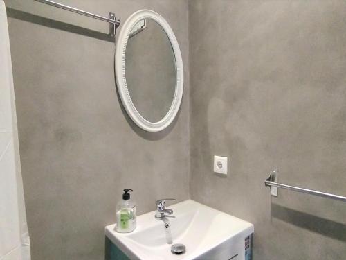a bathroom with a sink and a mirror on the wall at Holiday Home Rainbow by Interhome in Benidorm