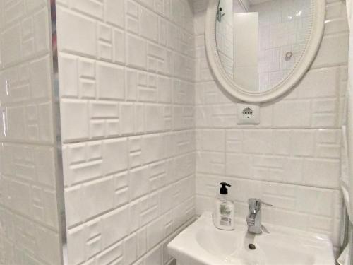 a white bathroom with a sink and a mirror at Holiday Home Rainbow by Interhome in Benidorm