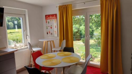 a dining room with a table and chairs and a window at Haus Emmerblick in Schieder-Schwalenberg