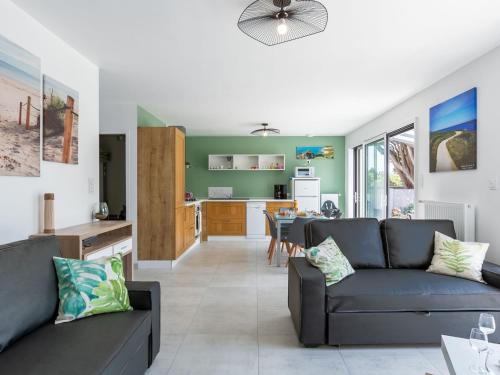 a living room with a couch and a kitchen at Holiday Home Palet Breton by Interhome in Locquirec