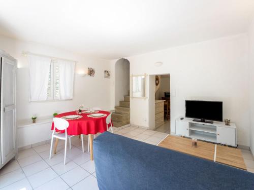 a living room with a red table and a tv at Holiday Home Centre Nyons by Interhome in Nyons