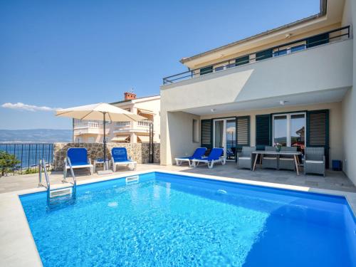 a swimming pool in front of a house at Holiday Home Villa Vali 2 by Interhome in Vrbnik