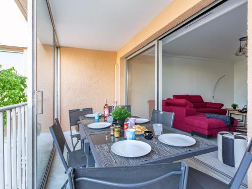a dining room with a table and a couch at Apartment Le Phenicia by Interhome in Saint-Laurent-du-Var