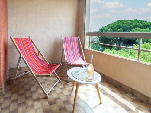 - un balcon avec une fenêtre doté de 2 chaises et d'une table dans l'établissement Studio Les Regates-2 by Interhome, à Hyères