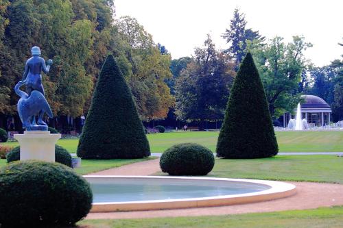 a statue of a woman in a fountain in a park at Apartmá v srdci Poděbrad in Poděbrady