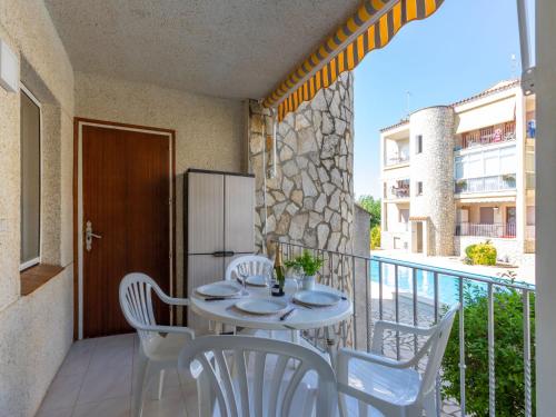 a patio with a table and chairs on a balcony at Apartment Flamicell by Interhome in Empuriabrava