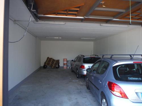 a garage with two cars parked in it at Villa Bianca in Varenna