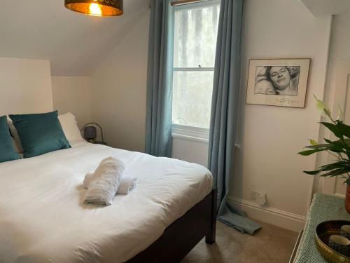 a bedroom with a bed with a towel on it at Cheltenham Road One Bedroom Apartment in Bristol