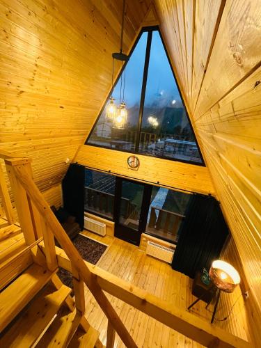 an overhead view of a wooden room with a large window at Cottage Carpe Diem in Stepantsminda