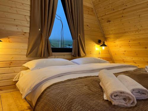 a bedroom with a large bed with a window at Cottage Carpe Diem in Stepantsminda