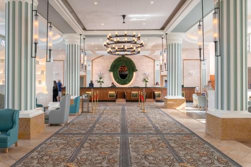 a rendering of the lobby of a hotel with a christmas wreath at Dream Castle Hotel Marne La Vallee in Magny-le-Hongre