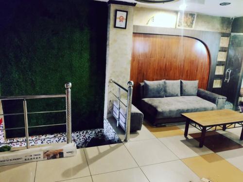 a living room with a couch and a table at Hotel Novelty in Jammu
