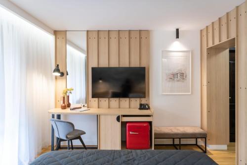 a bedroom with a desk with a television and a chair at Cabana Bistrita in Durau
